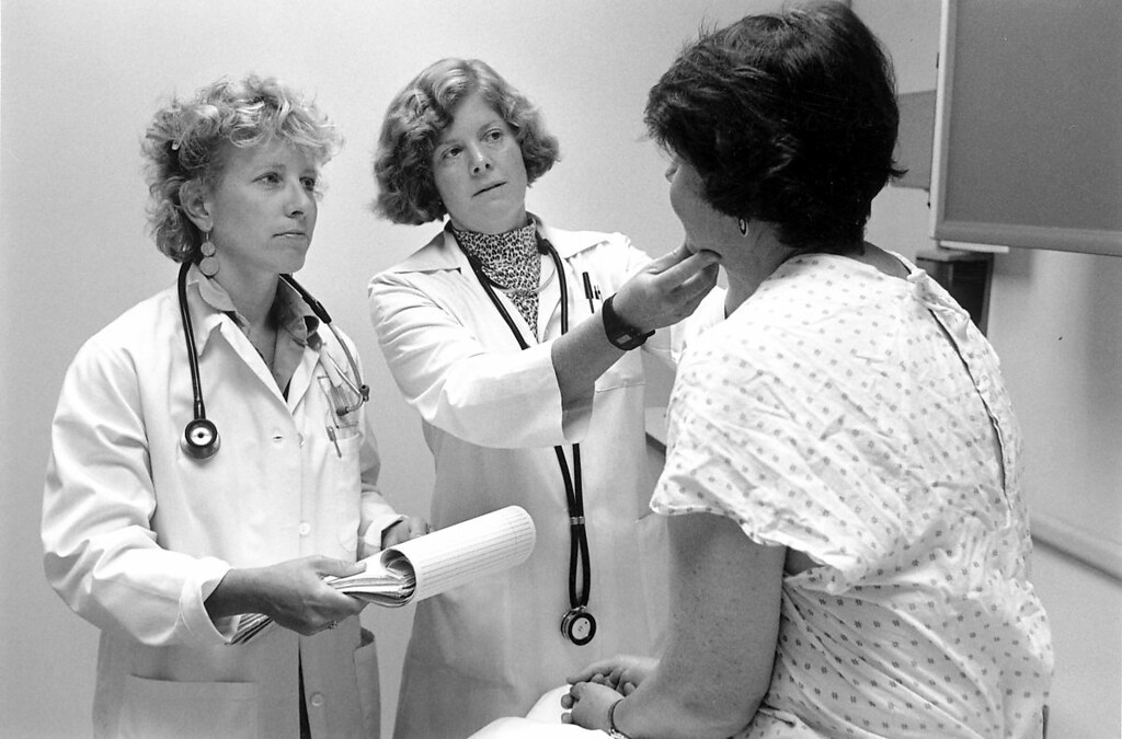Two clinicians reviewing information with a patient